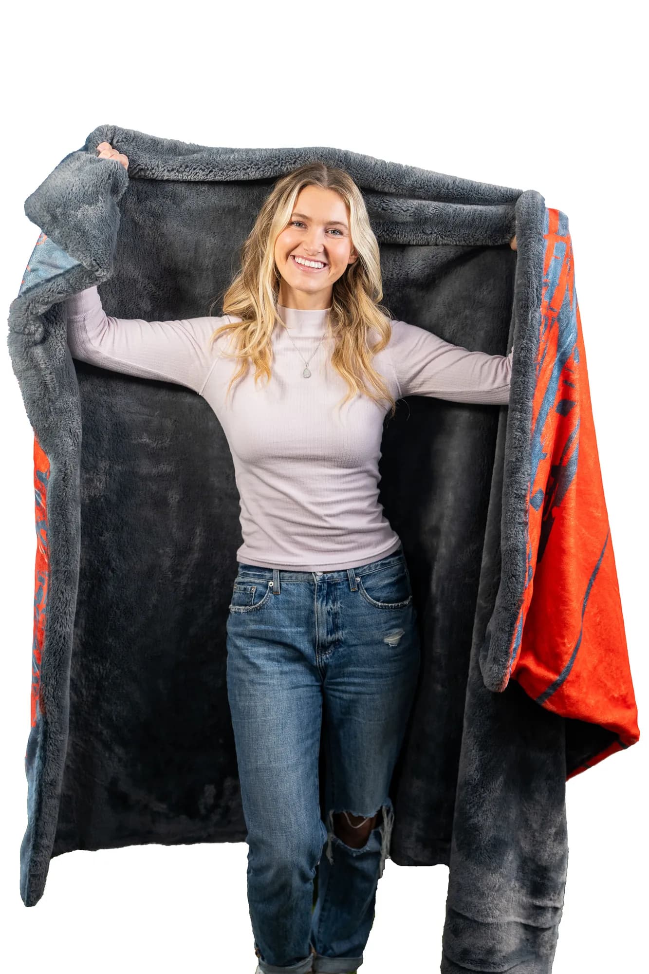A woman opening up a heavyweight custom printed keepsake blanket with a plush charcoal reverse